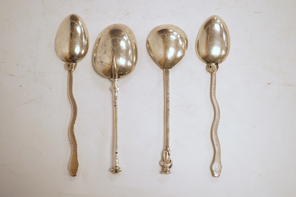 An 18th century silver apostle spoon, indistinct marks, 17cm, a continental white metal spoon with scroll handle and a pair of unmarked white metal spoons with serpent handles.